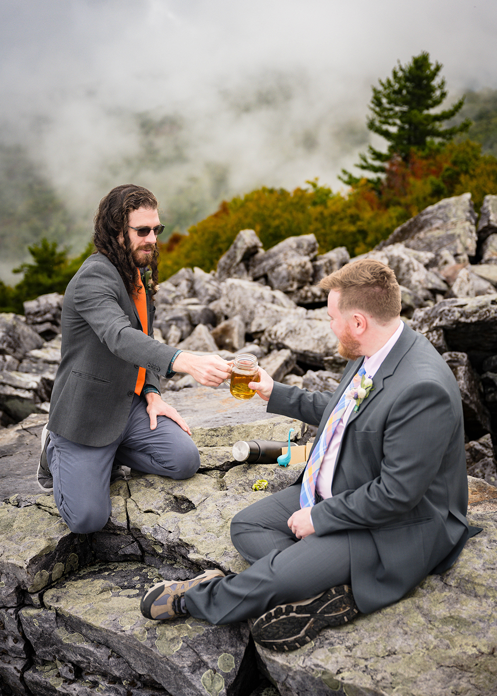 A gay couple shares the tea they've created during their tea unity ceremony atop Blackrock Summit in Shenandoah National Park on a foggy fall day.