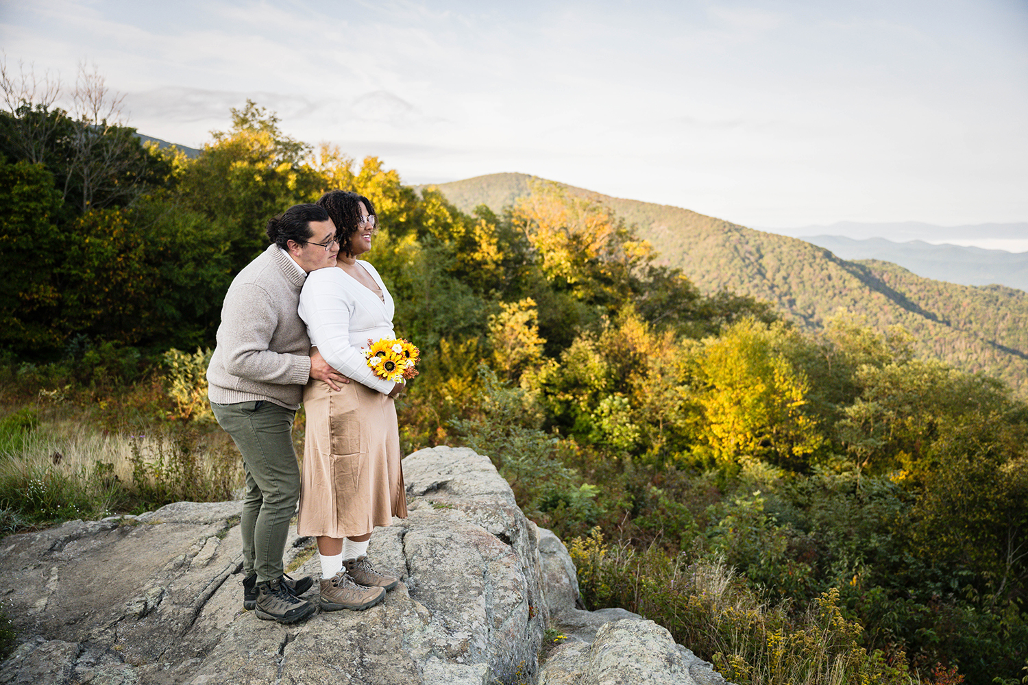 A couple enjoys the sunrise together on their elopement day at Timber Hollow Overlook.