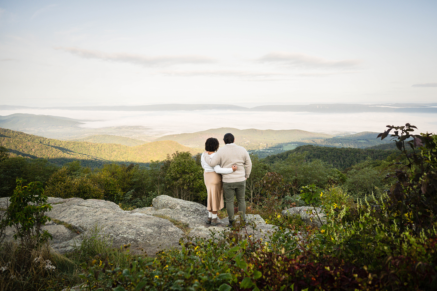 A couple enjoys the sunrise together on their elopement day at Timber Hollow Overlook.