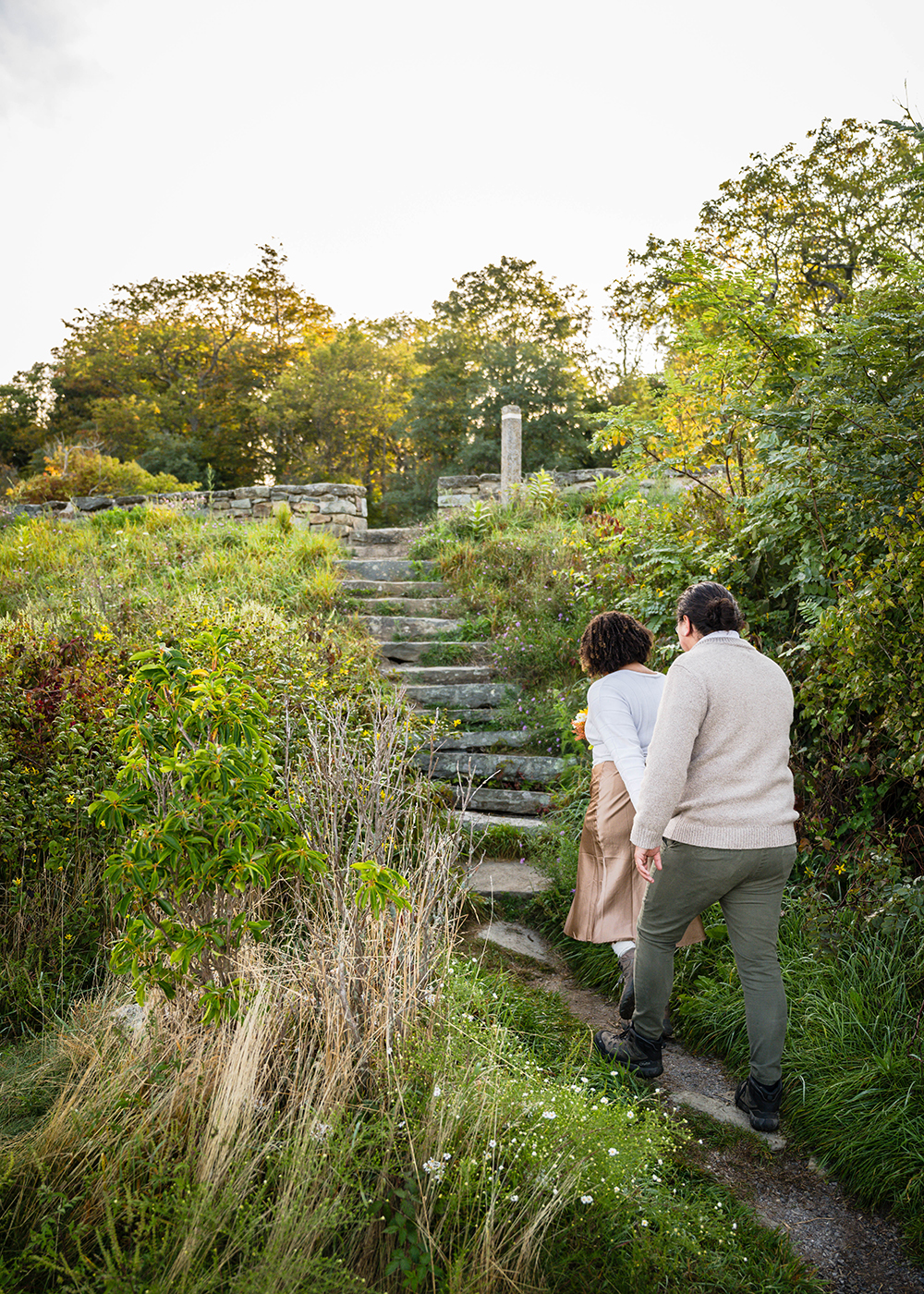 A couple on their elopement wedding day walk hand-in-hand up the stairs to return to the parking lot at Timber Hollow Overlook.