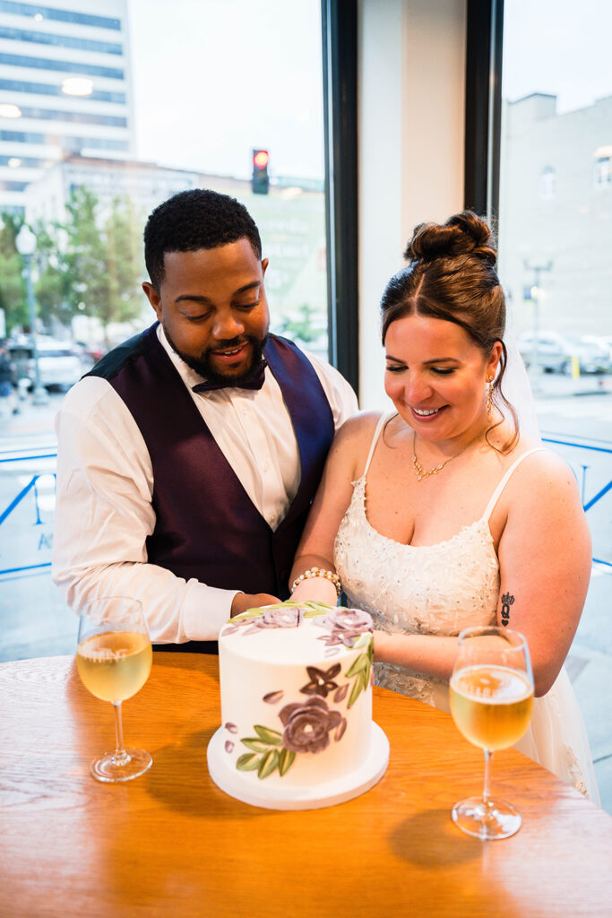 A couple on their elopement day in Virginia cut their wedding cake.