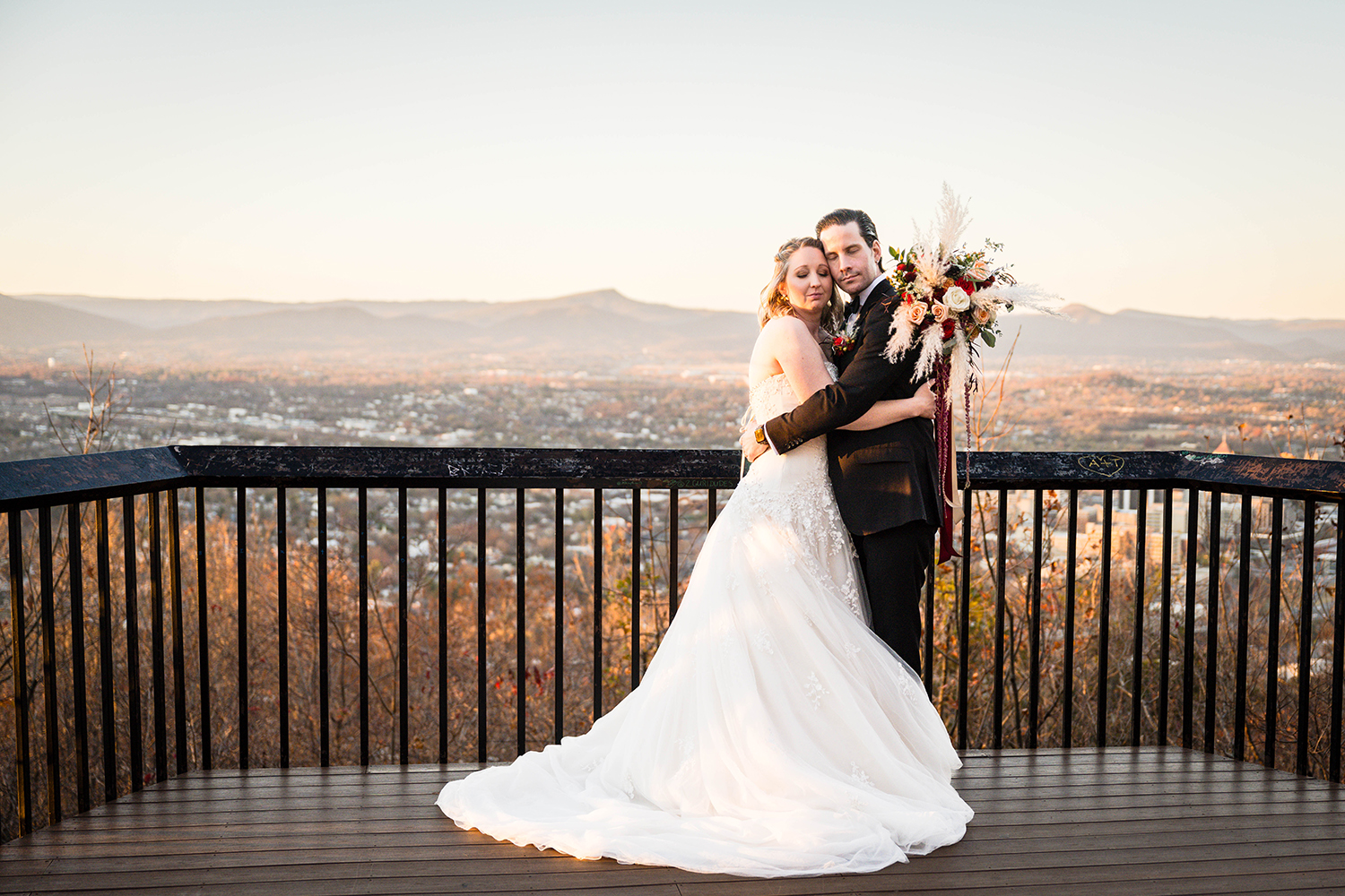 A bride and groom hug one another during their elopement day in Roanoke, Virginia and take a moment to themselves and close their eyes to breathe in their first moment as husband and wife.