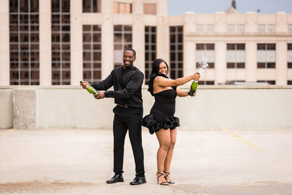 A Black couple pops champagne to celebrate their engagement in Downtown Roanoke.