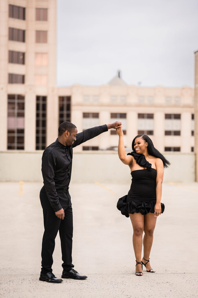 A man twirls a woman during a Roanoke engagement photos in Virginia.
