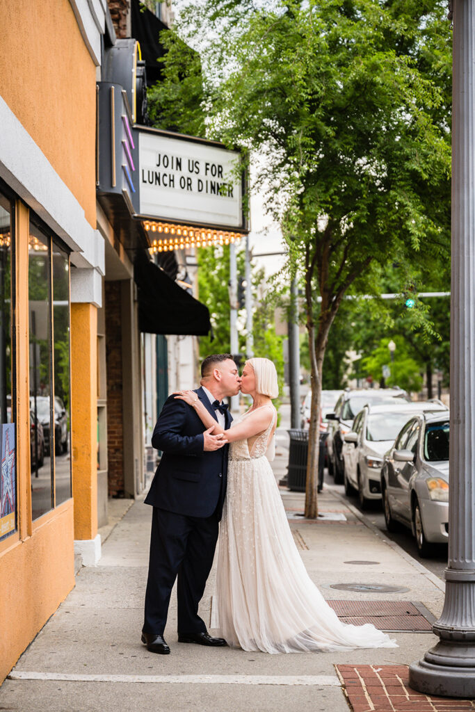 An elopement couple stop for a kiss in Downtown Roanoke.