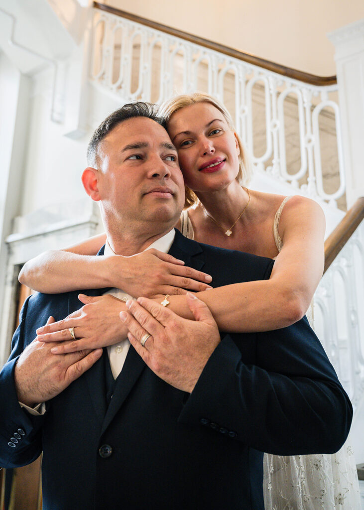 An elopement couple poses together for a photo in the Liberty Trust Hotel in Roanoke, Virginia.