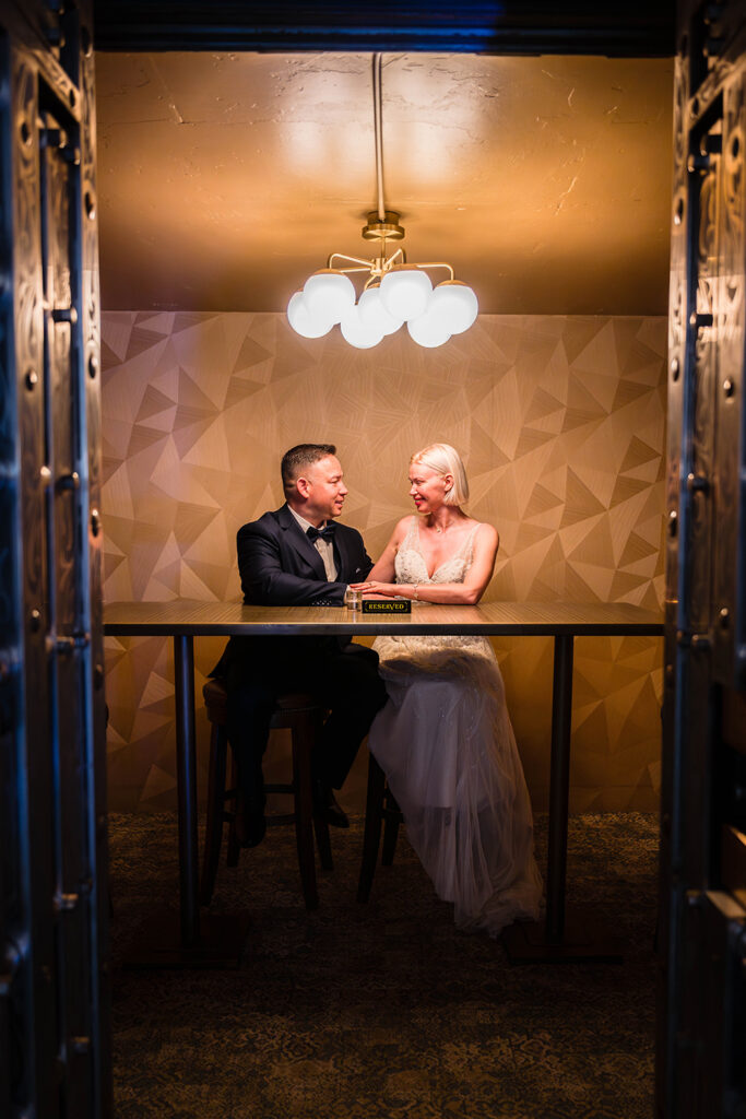 A wedding couple sits inside The Vault at the Liberty Trust Hotel.