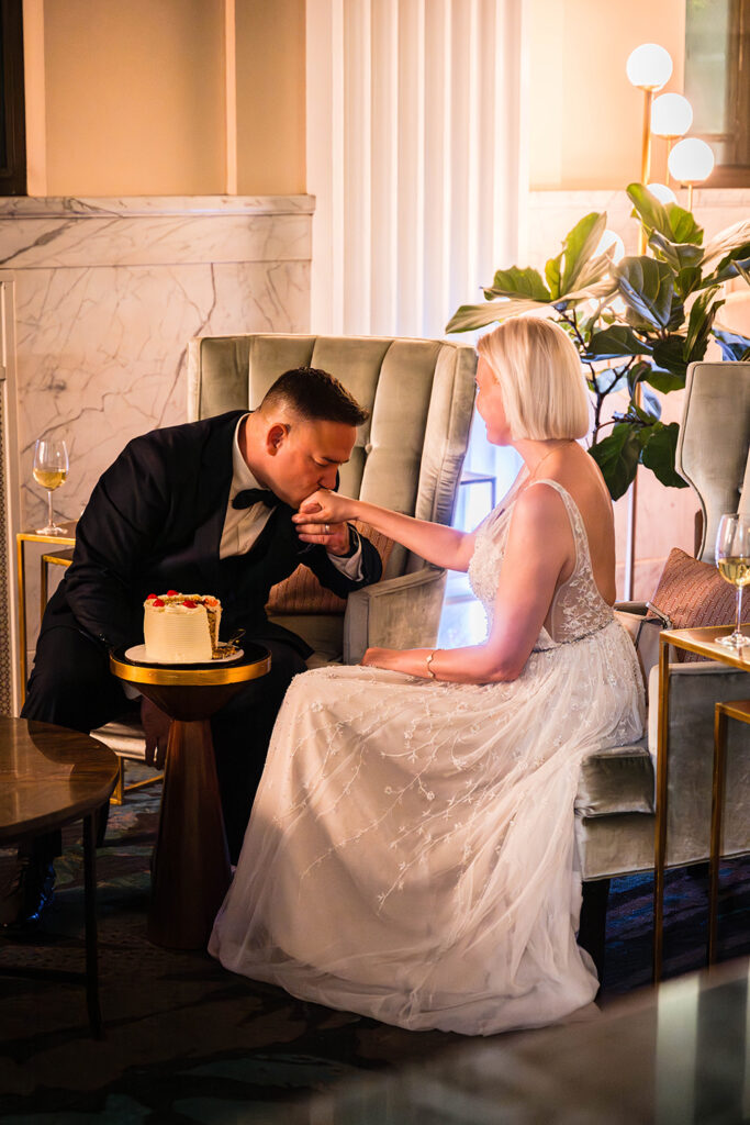 A man kisses a woman's hand while sitting in the lobby of the Liberty Trust Hotel in Roanoke, Virginia.