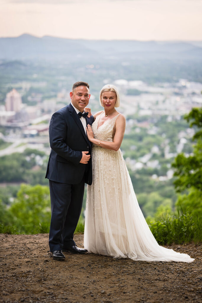 An elopement couple poses together at a special spot at Mill Mountain in Roanoke, Virginia.