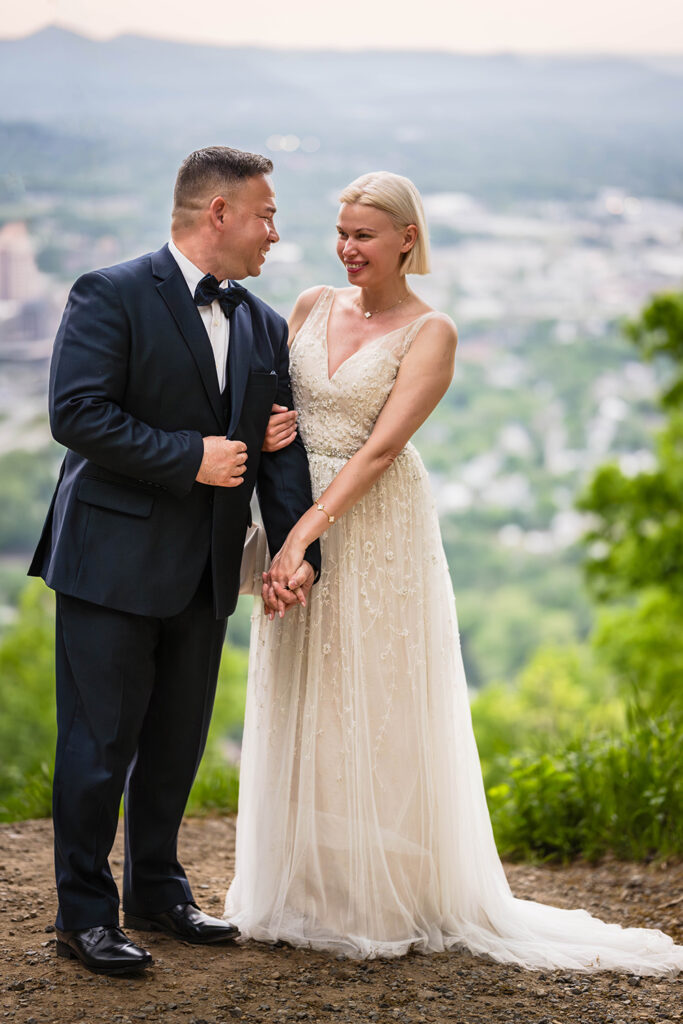 A couple poses together at a special spot at Mill Mountain in Roanoke, Virginia.