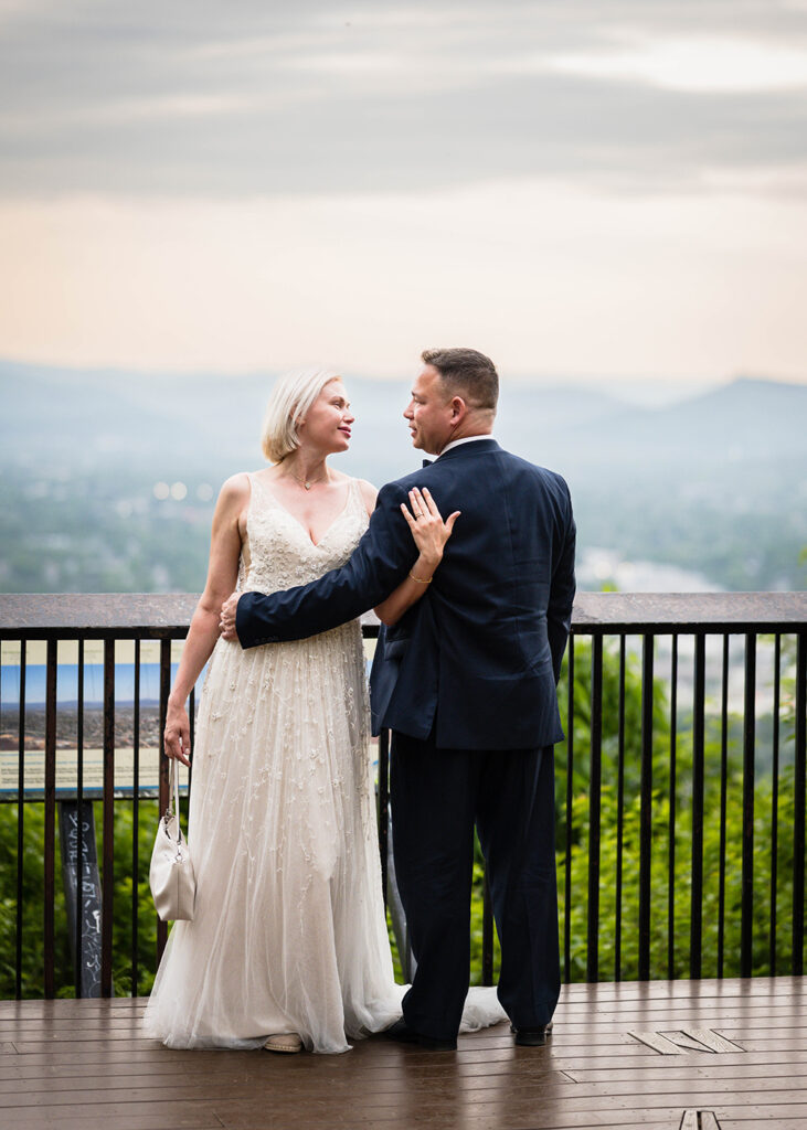 A wedding couple poses together at Mill Mountain Overlook in Roanoke, Virginia.