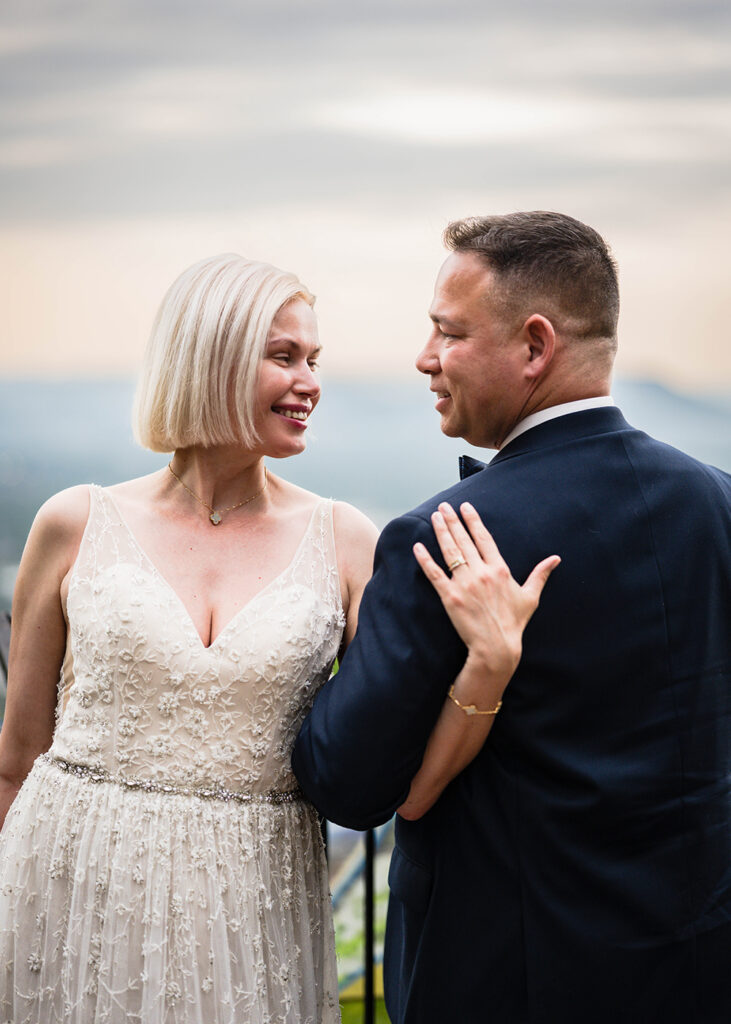 A couple poses together at Mill Mountain Overlook in Roanoke, Virginia.