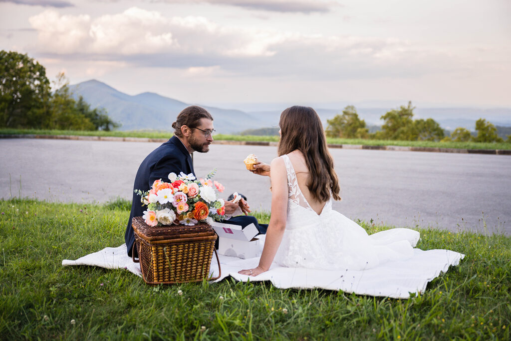 A wedding couple enjoy their Blue Ridge mountain wedding day with cupcakes and an amazing sunset view at Cahas Mountain Overlook.