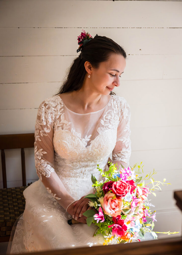 A bride poses for a portrait inside a farmhouse during her Martinsville, Virginia elopement day.