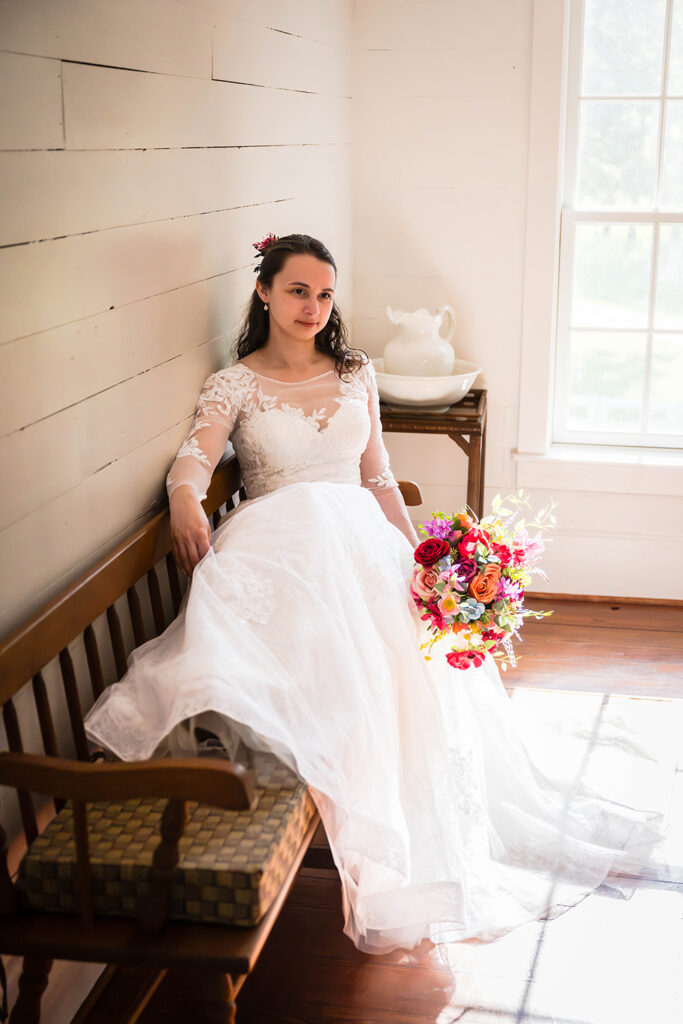 A bride poses for a portrait inside a farmhouse during her Martinsville, Virginia elopement day.