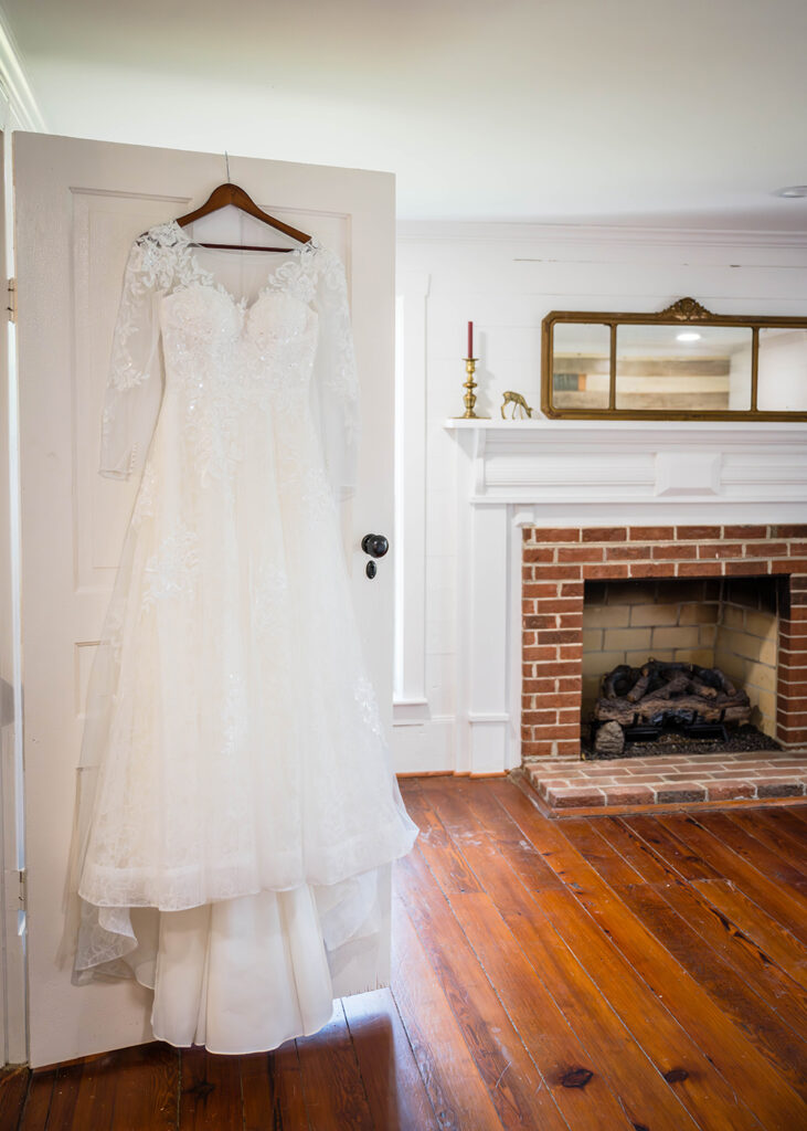 A wedding dress hangs on a door inside of a modern farmhouse in Martinsville, Virginia.
