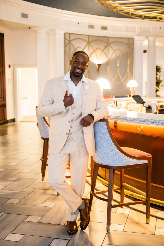 A Black groom poses in the 1882 Lobby Bar in Hotel Roanoke.