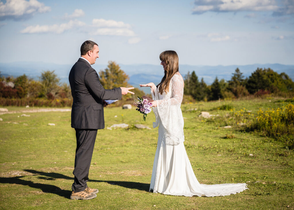 A wedding couple plays rock, paper, scissors to determine who will read their vows first during their Massie Gap ceremony in Grayson Highlands State Park.
