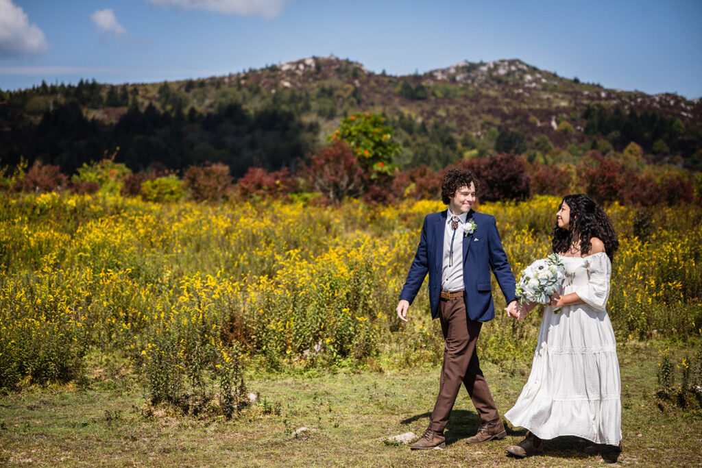 A groom leads a bride on a path in Massie Gap for their Grayson Highlands State Park elopement.