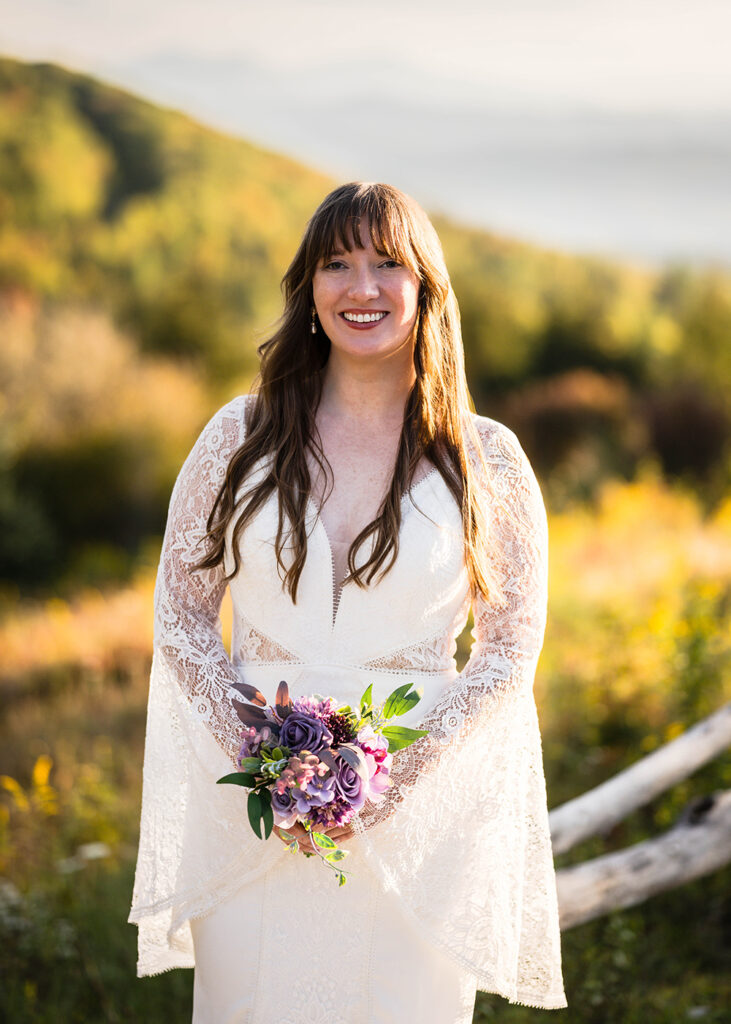A newlywed spouse poses for a photo along the Massie Gap trail on her elopement day.