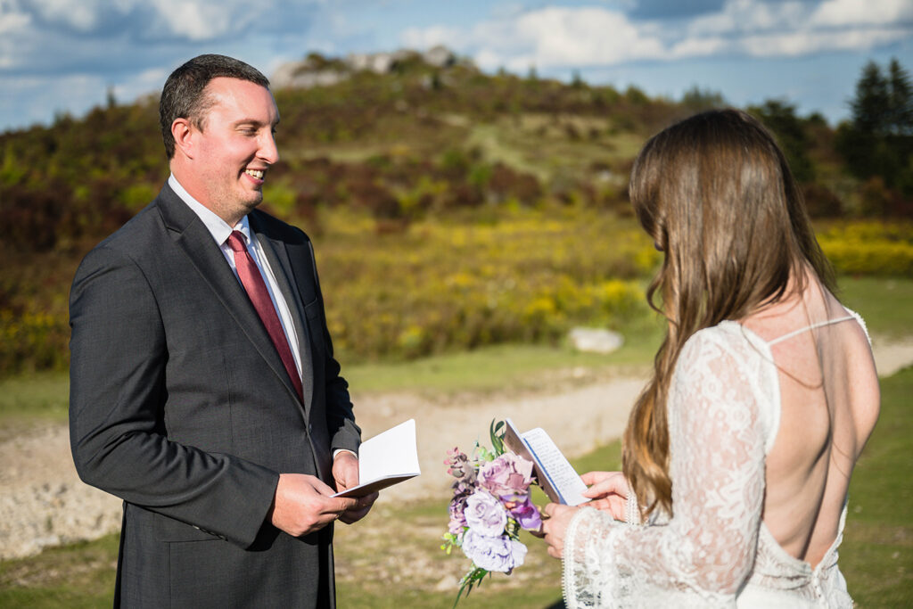 An elopement couple reads their wedding vows at Massie Gap in Grayson Highlands State Park in Virginia.