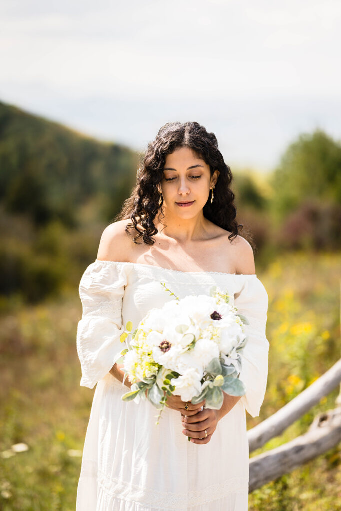 A bride poses with her wedding bouquet along Massie Gap Trail.