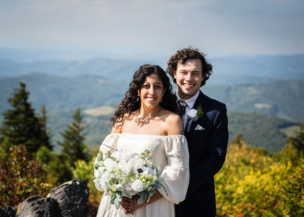 A couple smiles at Little Pinnacle for their Grayson Highlands State Park elopement day.