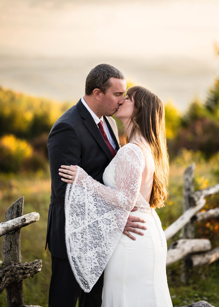 An elopement couple goes in for a kiss as the sun sets at Massie Gap.