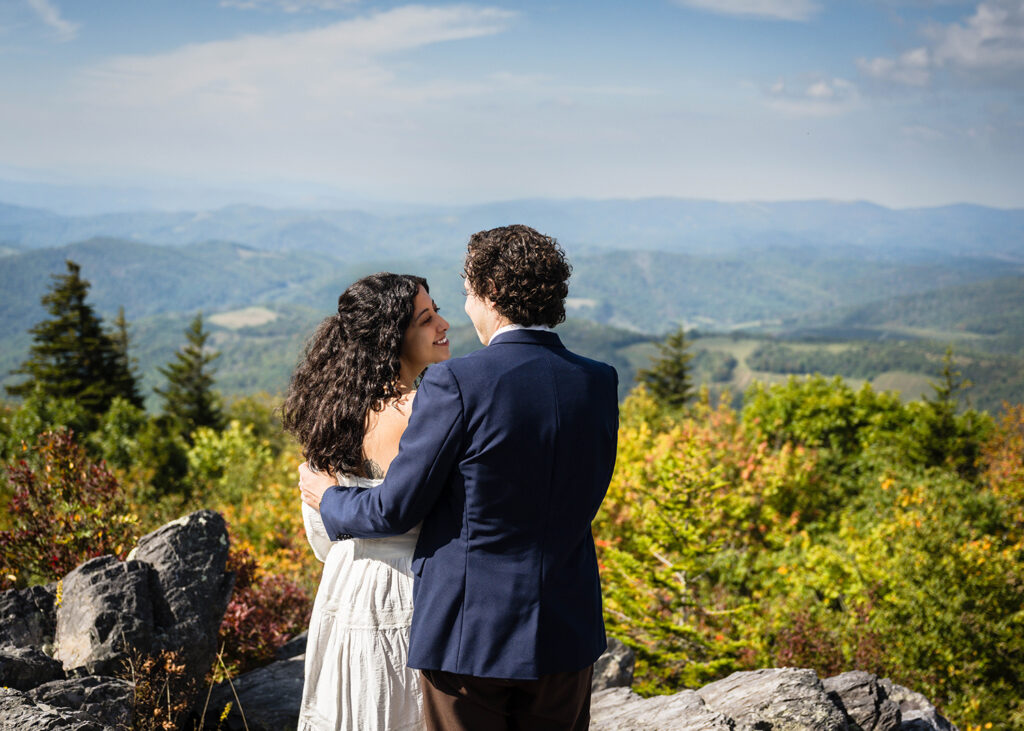 A couple smiles at one another on their Grayson Highlands State Park elopement day.