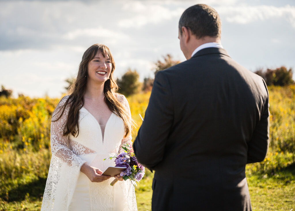 An elopement couple reads their wedding vows at Massie Gap in Grayson Highlands State Park in Virginia.