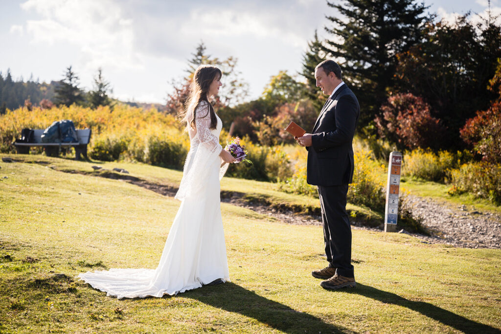 A wedding couple reads their elopement vows at Massie Gap in Grayson Highlands State Park in Virginia.