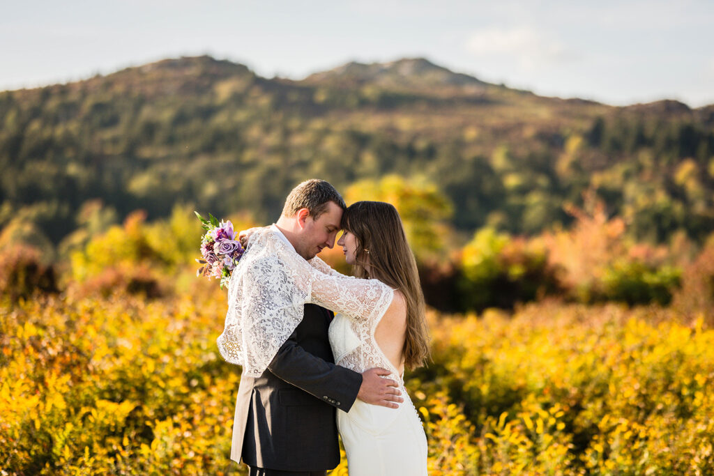 A wedding couple embraces for a photo at Massie Gap in Grayson Highlands State Park.