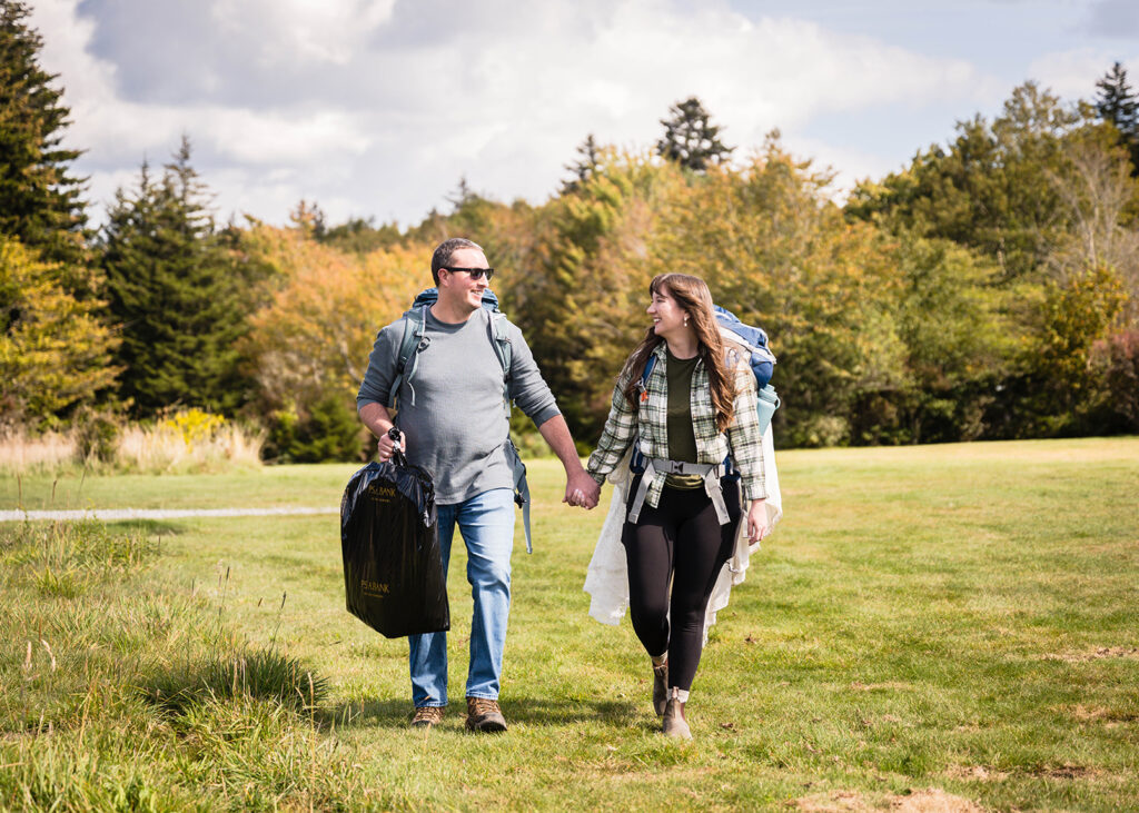 A couple holds hands and walks together to get ready for their Massie Gap elopement day.