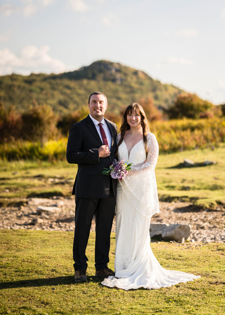 A wedding couples take a portrait together at golden hour in Grayson Highlands.