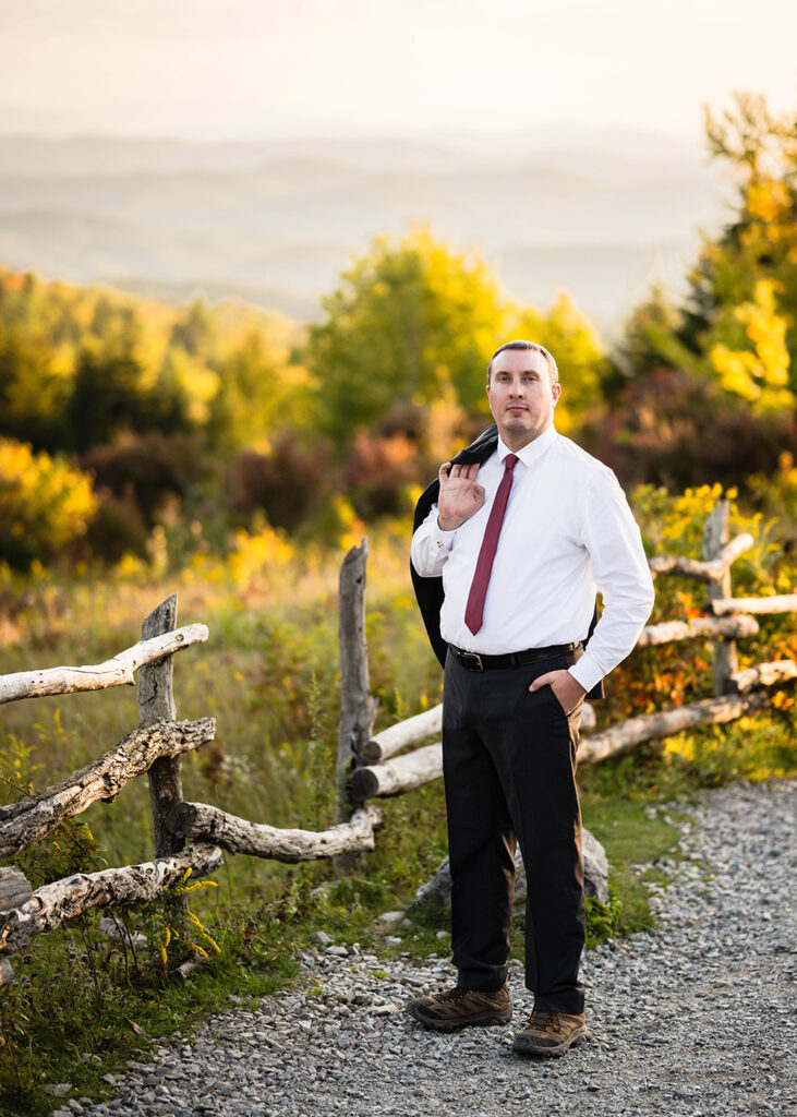 A newlywed spouse poses for a photo along the Massie Gap trail on his elopement day.