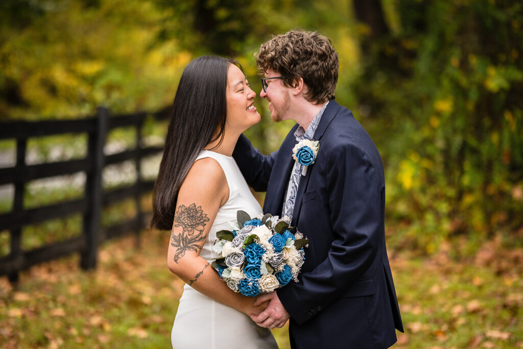 A wedding couple stands outside for a photo and goes in for a kiss at Highland Hideaways.