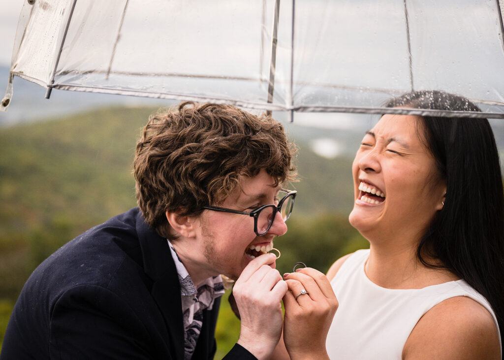 An LGBTQ+ couple shares in a funny moment together during their Grayson Highlands elopement wedding ceremony.