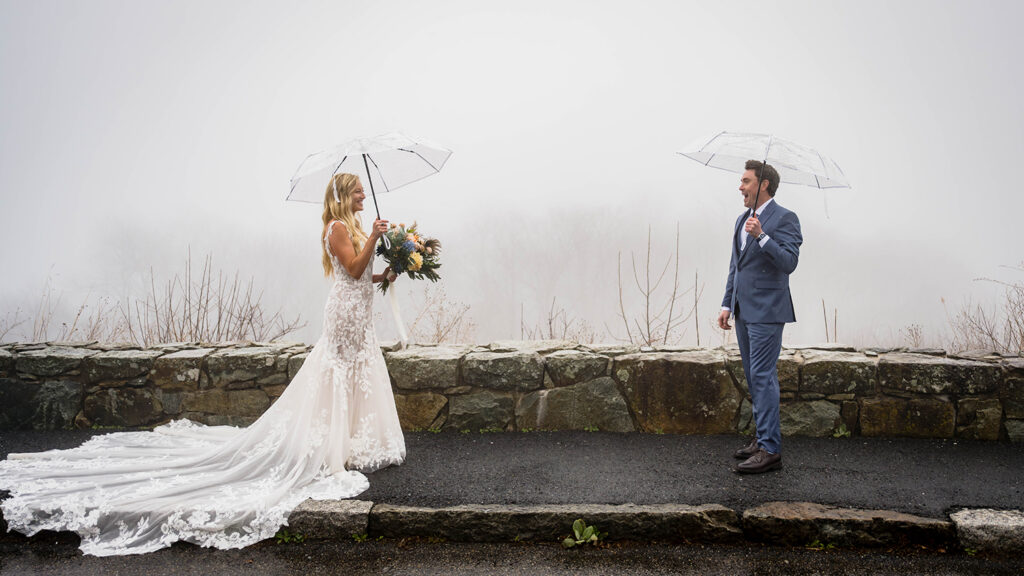 A groom turns to face the bride and smiles widely during their first look at Thorofare Mountain Overlook in Shenandoah National Park.