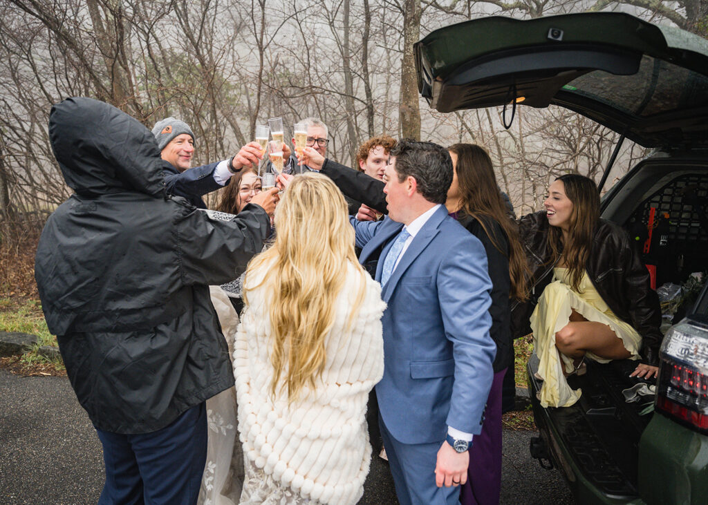 A group huddles together to share in a champagne toast.