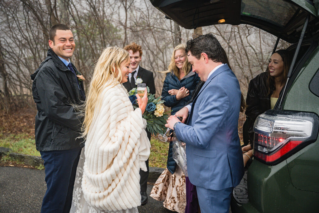 A group huddles together to share in a champagne toast.