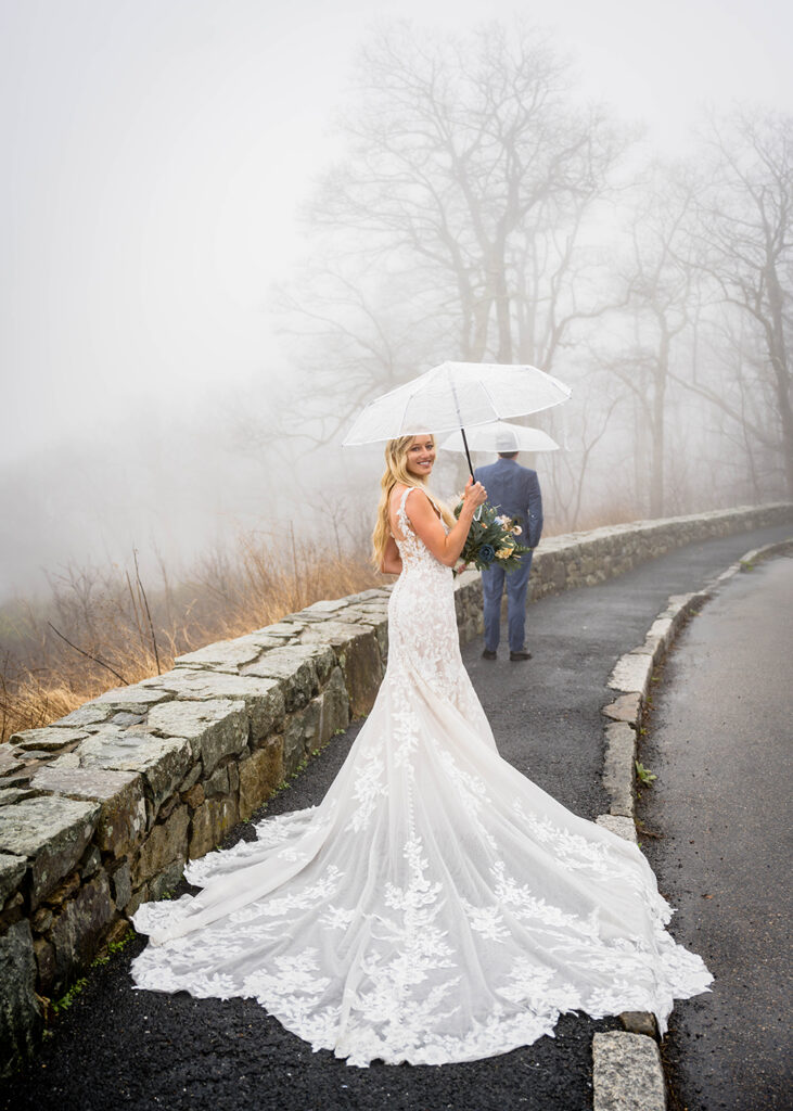A bride turns and smiles for a photo during her first look at Thorofare Mountain Overlook in Shenandoah National Park.