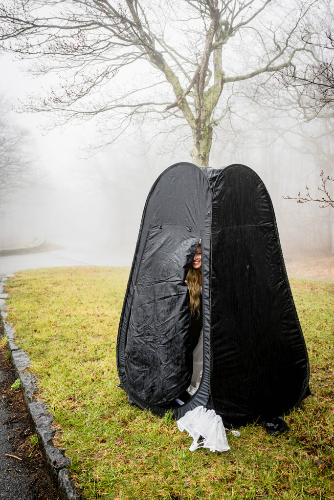 A bride peeks out of a changing tent at Thorofare Mountain Overlook.
